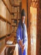 Librarian with ancient manuscripts in a Chinguetti family library