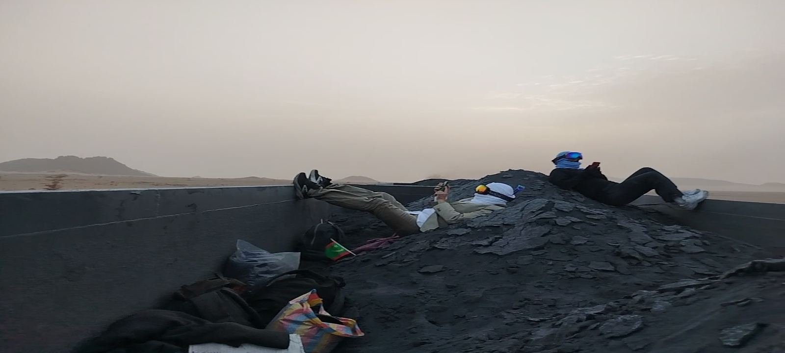 Travellers resting on the iron ore train on its way to Nouadhibou